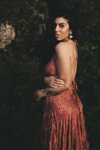 Portrait of young woman standing outdoors