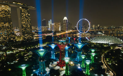 Illuminated city against sky at night