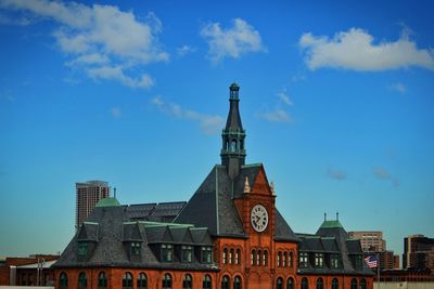 Low angle view of buildings against blue sky