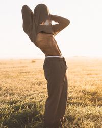 Man standing on field against clear sky