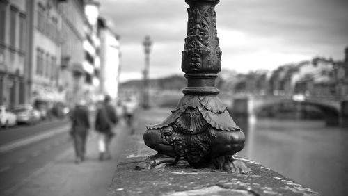 Close-up of old metal on street against sky