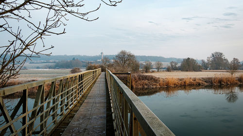 Bridge over canal against sky