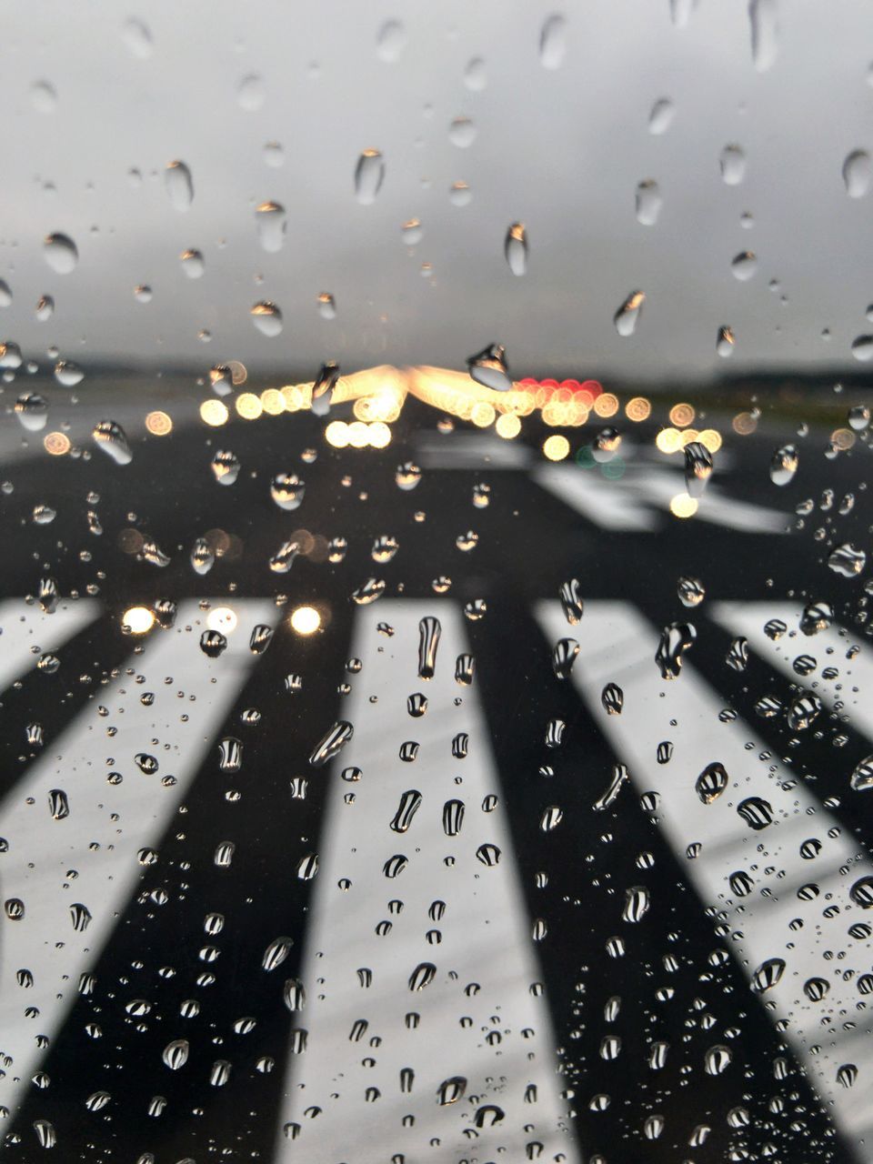 WATER DROPS ON GLASS WINDOW OF CAR