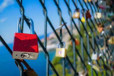 Close-up of heart shape sign hanging on metal