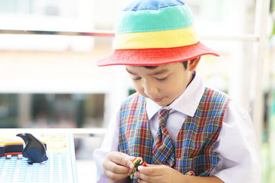 Midsection of boy holding mobile phone