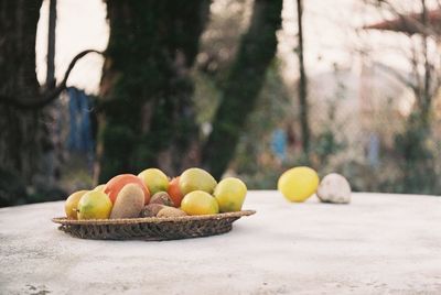 Close-up of fruits in basket on table