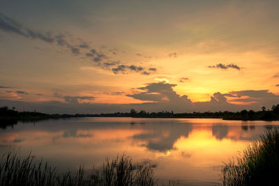 Scenic view of lake against romantic sky at sunset