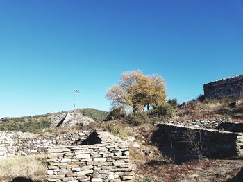 Stack of rocks against clear blue sky
