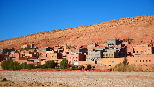 Residential buildings against clear blue sky