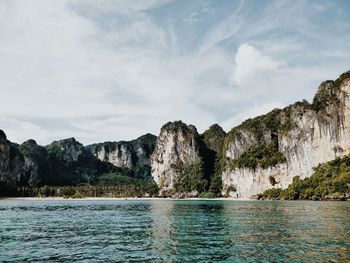 Scenic view of sea and mountains against sky