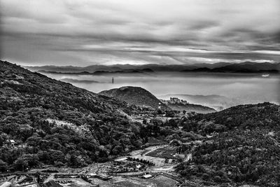Scenic view of mountains against cloudy sky