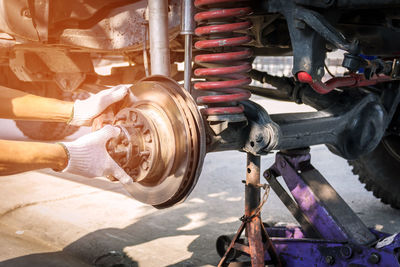 Close-up of mechanic repairing damaged vehicle