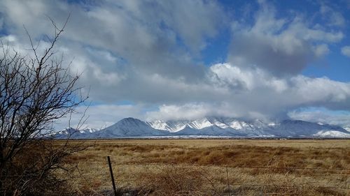 Scenic view of mountains against cloudy sky