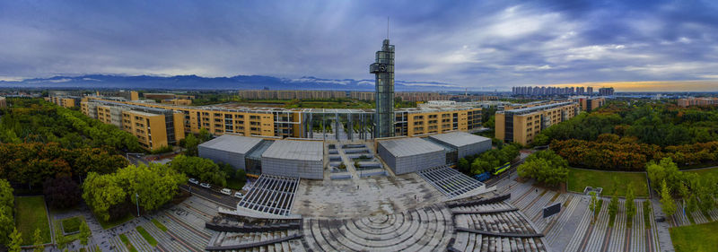 High angle view of buildings against cloudy sky