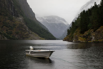 Boat in lake against mountains