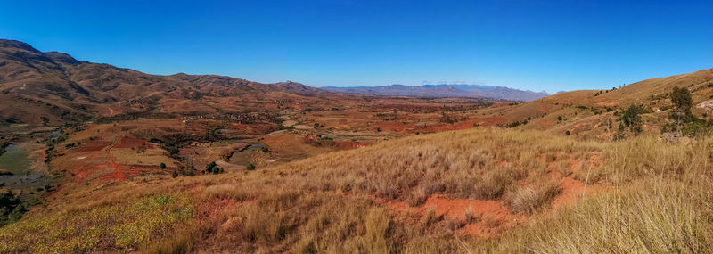 Scenic view of mountains against clear blue sky