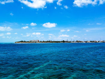 Scenic view of sea against blue sky