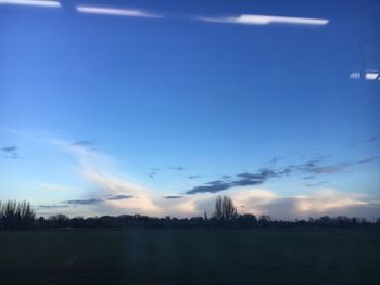 Scenic view of field against blue sky