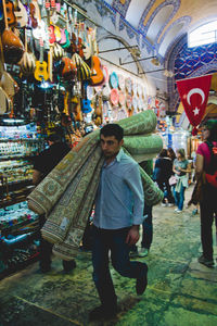 Full length of man standing at market stall in city