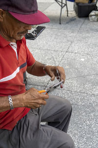 Midsection of man using mobile phone