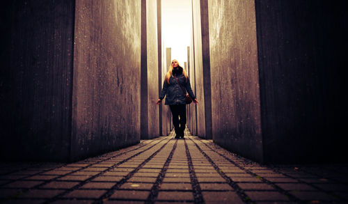 Full length of woman standing by railing