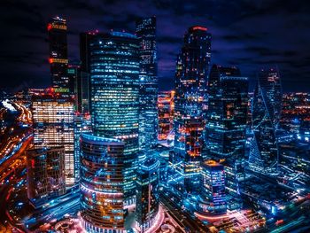 Aerial view of illuminated buildings in city at night