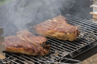 High angle view of meat on barbecue grill