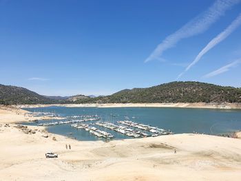 Scenic view of beach against blue sky