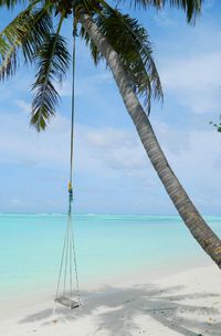 Sailboat on beach against sky