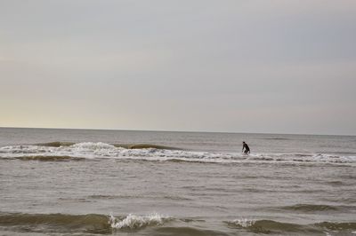Man standing on beach against clear sky