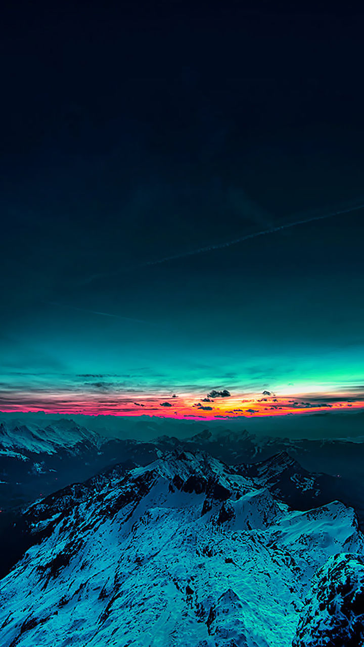 VIEW OF CALM BLUE SEA AGAINST MOUNTAIN