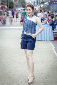 Full length portrait of woman standing outdoors