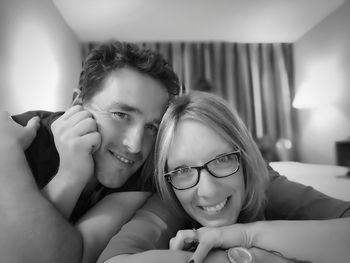 Portrait of smiling couple resting at home