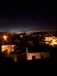 Illuminated cityscape against sky at night