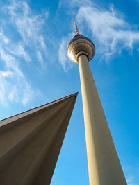 Low angle view of berlin tv tower against cloudy sky