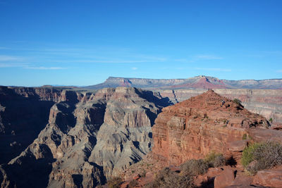 Scenic view of mountain against blue sky