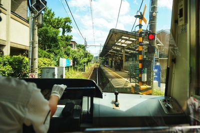 Man driving car against sky in city