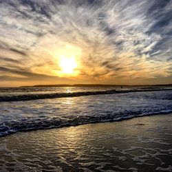 Scenic view of beach against sky during sunset