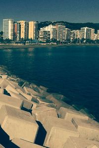 High angle view of sea and buildings against sky