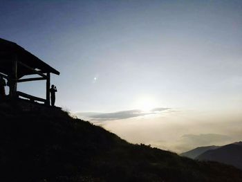 Scenic view of silhouette mountain against sky at sunset