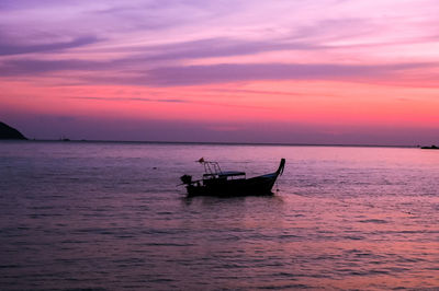 Silhouette boat sailing on sea against sky during sunset