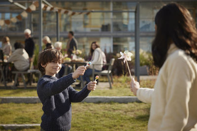 Smiling boy holding lollipops