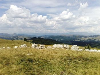 Scenic view of landscape against cloudy sky