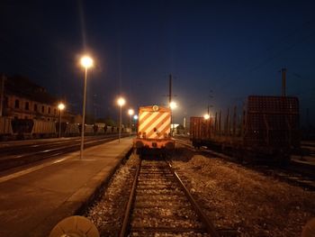 Train on illuminated street at night