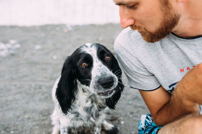 Happy owner of russian cocker spaniel dog, responsibility of caring about pet