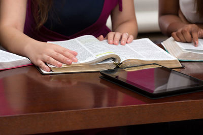 Midsection of woman reading book