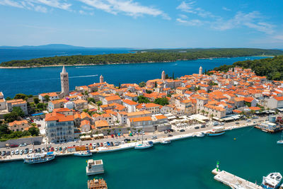 High angle view of townscape by sea against sky