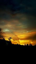 Silhouette of landscape against dramatic sky