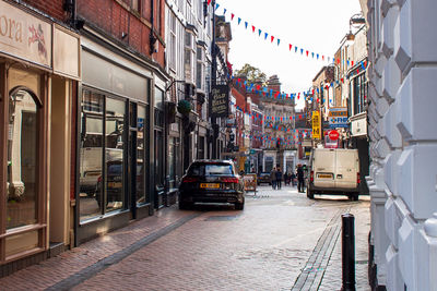 Cars on street amidst buildings in city