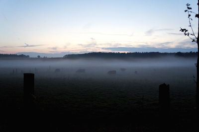 Scenic view of lake against sky during foggy weather